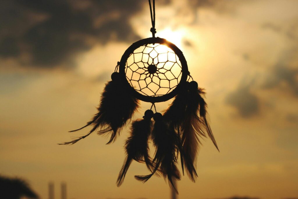 pexels photo 279467 279467 Silhouette of a dreamcatcher hanging against a serene sunset sky.