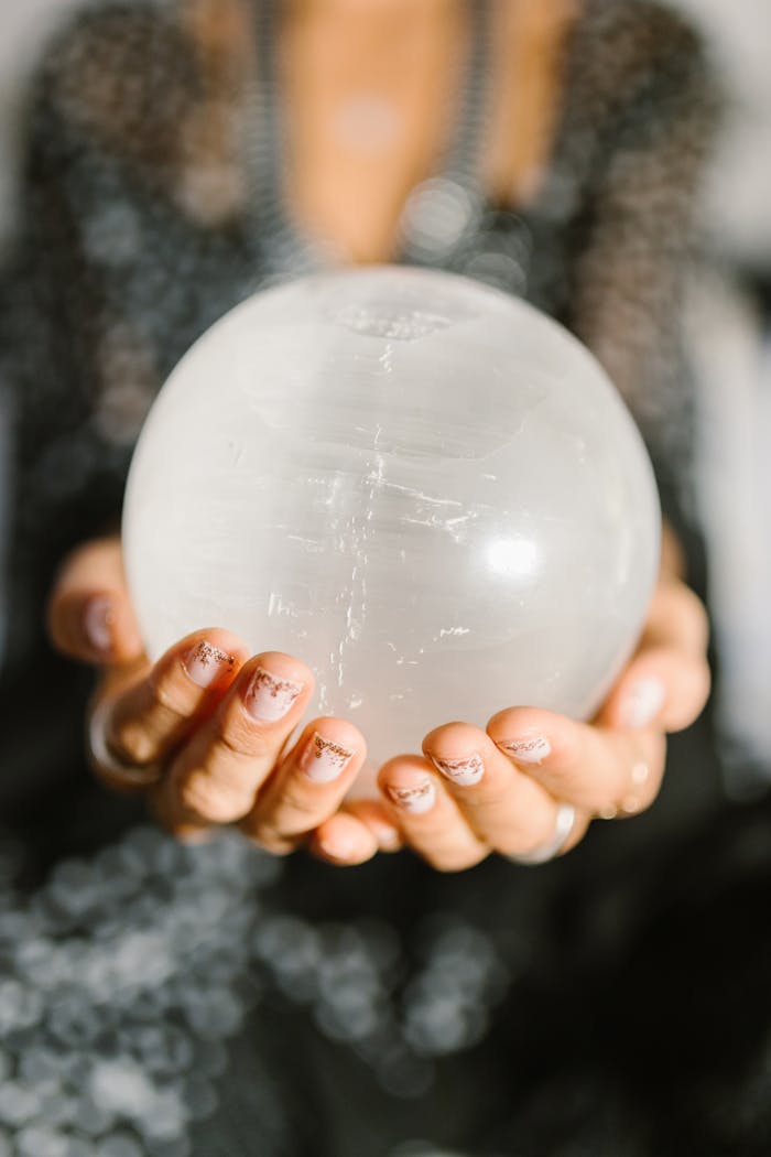 The Art of Drawing Readers In: Your attractive post title goes here Close-up of hands holding a clear crystal ball, ideal for spiritual or metaphysical themes.